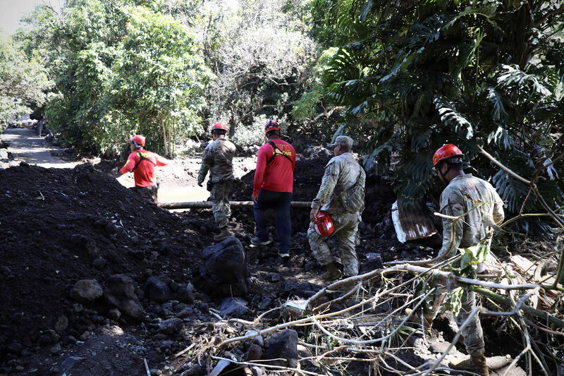 National Guard soldiers working in a flooded street after a hurricane.