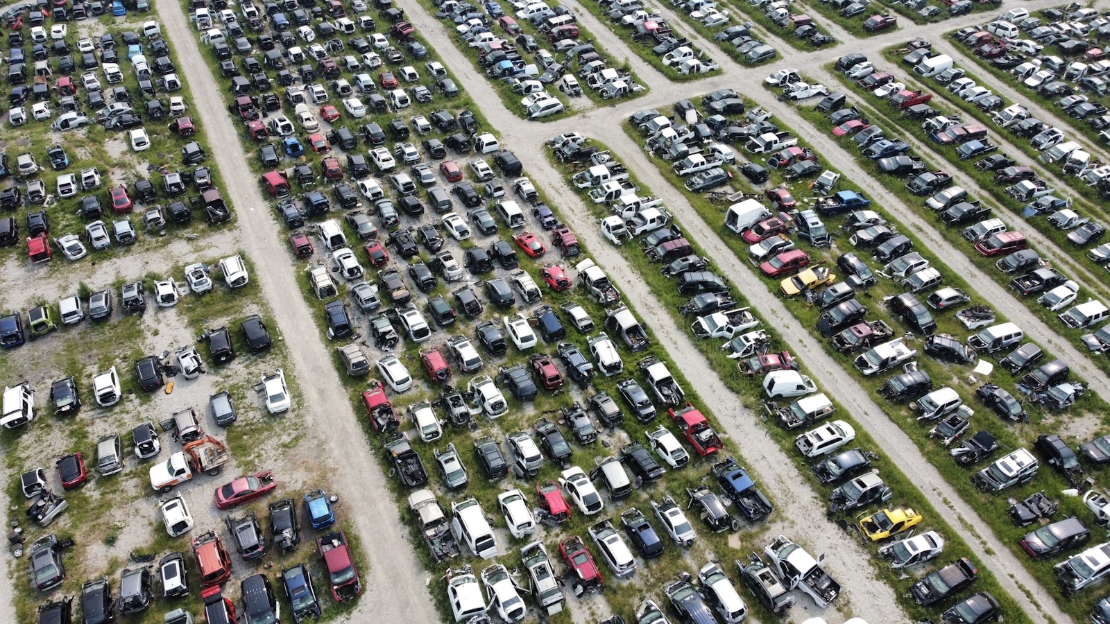 Aerial view of lots of cars lined up in a junk yard to be scrapped for parts in Calgary, Alberta Canada.