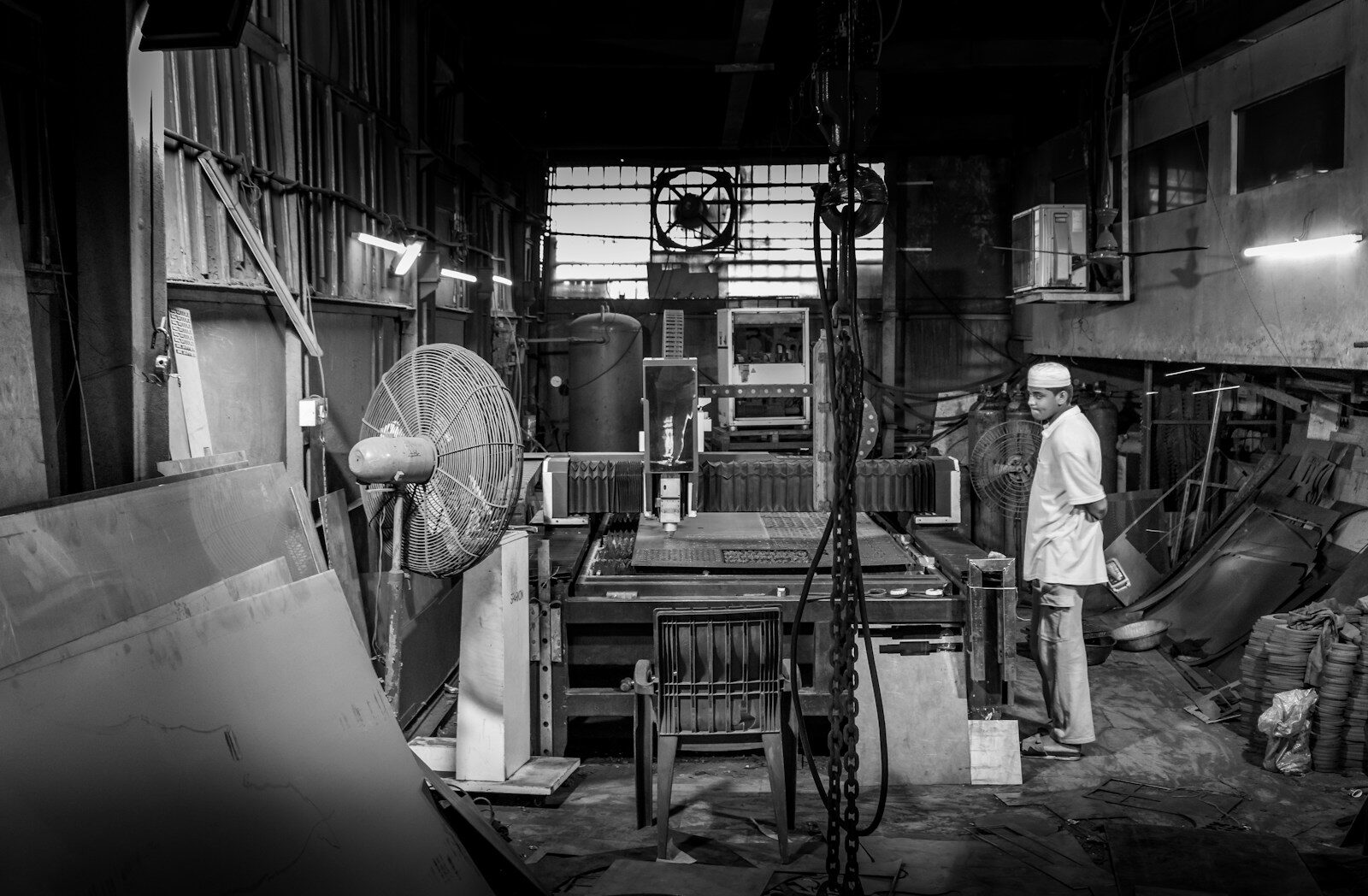 A metal fabrication workshop with a large CNC plasma cutter