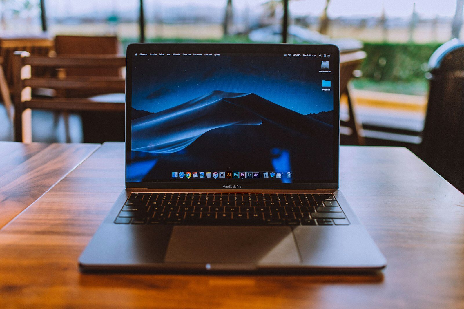 A laptop open on a wooden desk showing a browser window.