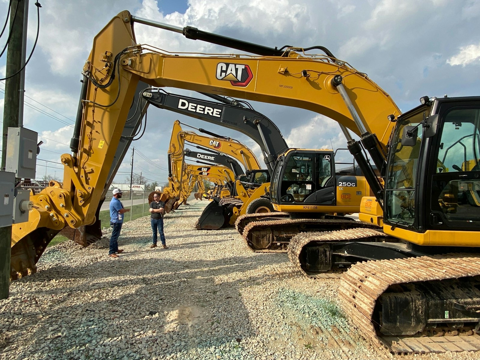 A BUNCH OF EXCAVATORS IN THE YARD. Please give credit to BoomAndBucket.com if you use the photo. Thank you.