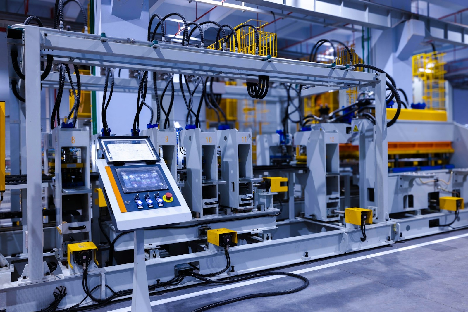 A view of the refrigerator manufacturing plant's fully automated side panel forming line.Translation: "Warning:Danger Prohibit reach into;elecric shock;must connect an earth terminal to the ground"