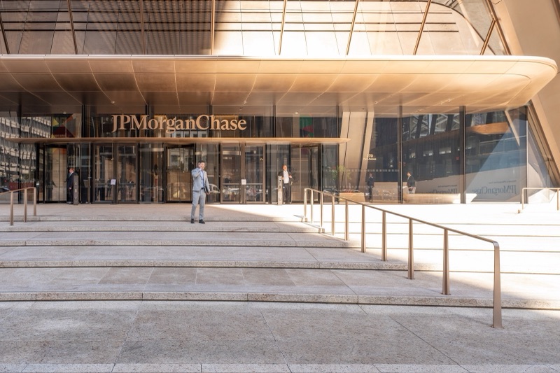 The entrance to JPMorgan Chase's headquarters at 270 Park Avenue in New York, with the company's name above glass doors and wide stone steps in front.