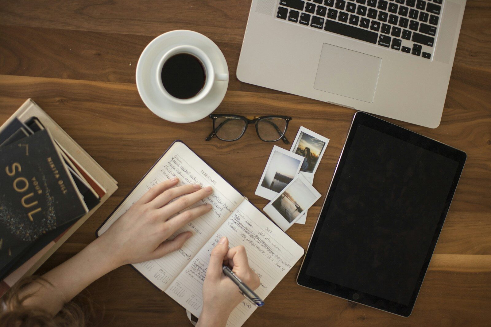 A writer working in a notebook at a desk