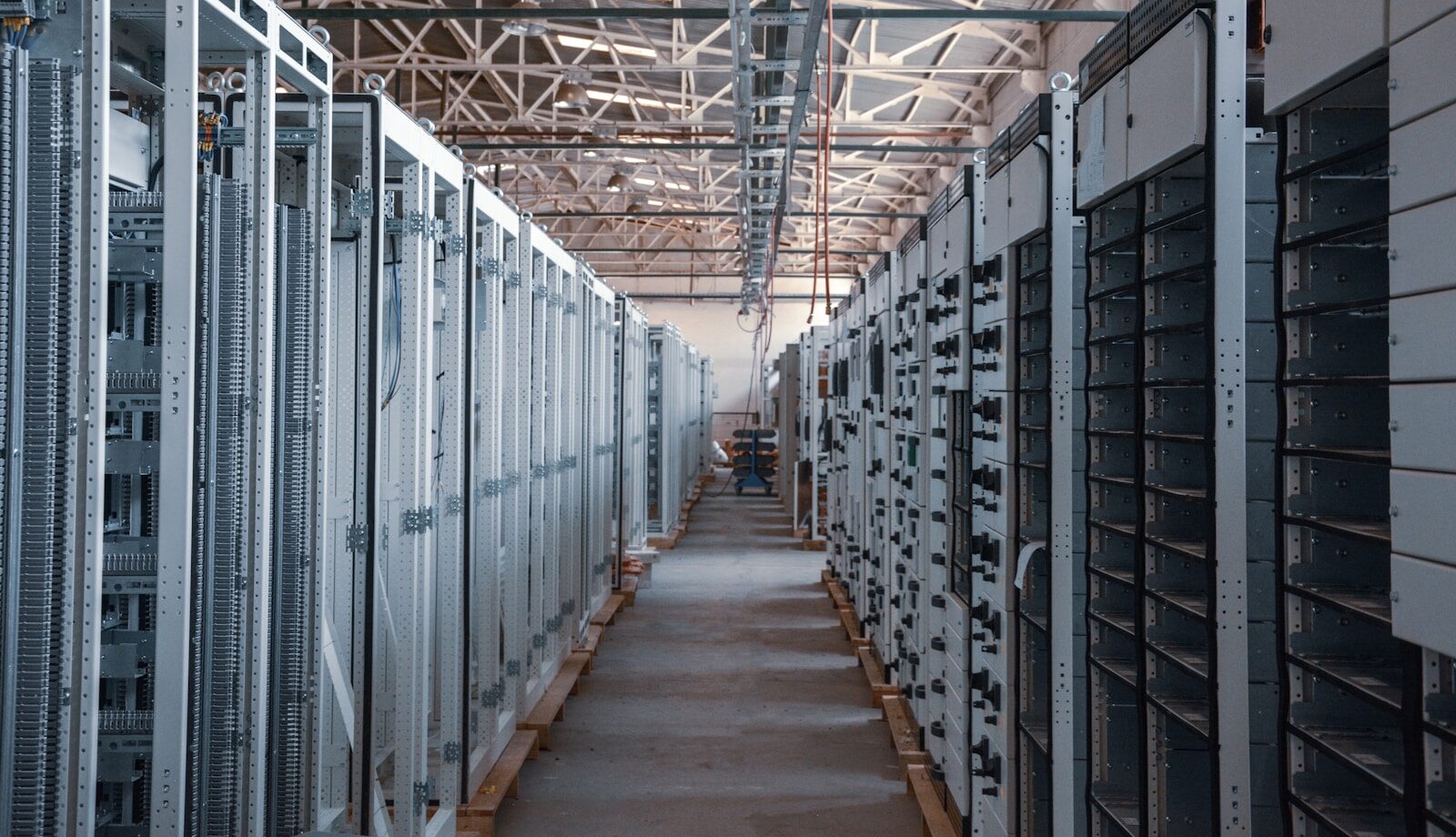 An aisle of equipment racks running the length of a data centre