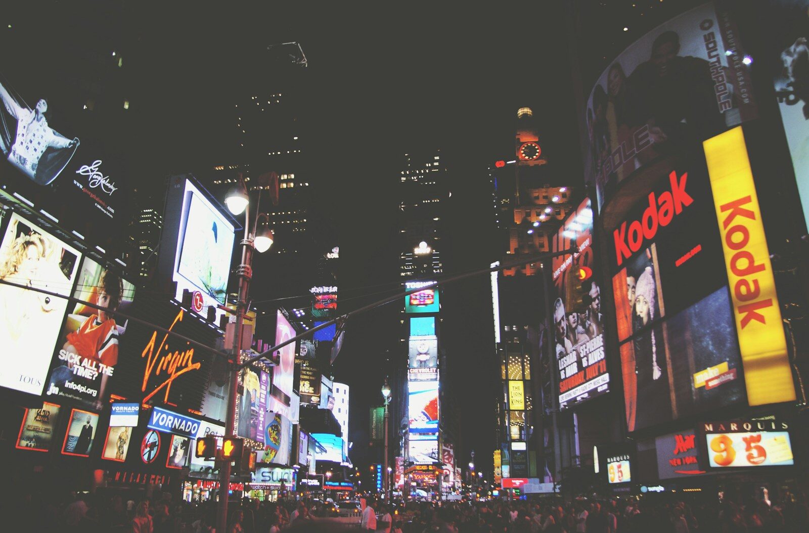 Times Square filled with people at night
