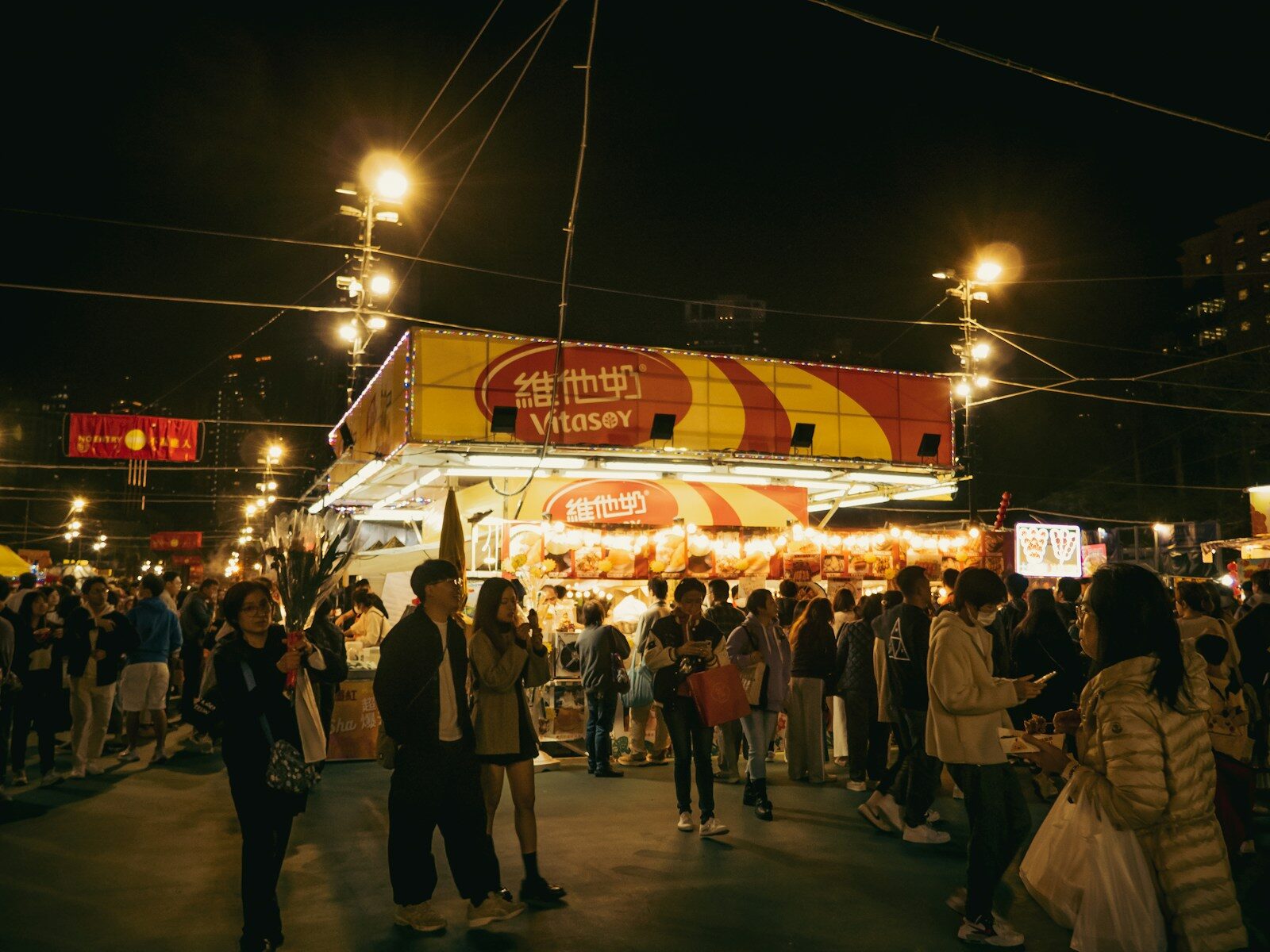 A night market lit with stalls and crowds at Victoria Park