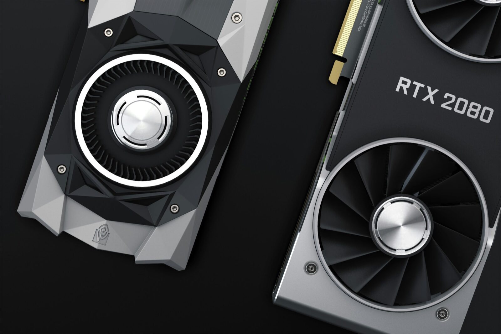 Two graphics cards seen from above on a black surface, one labelled RTX 2080, with their cooling fans visible.