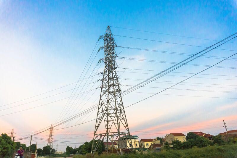 High-voltage transmission lines at dusk.
