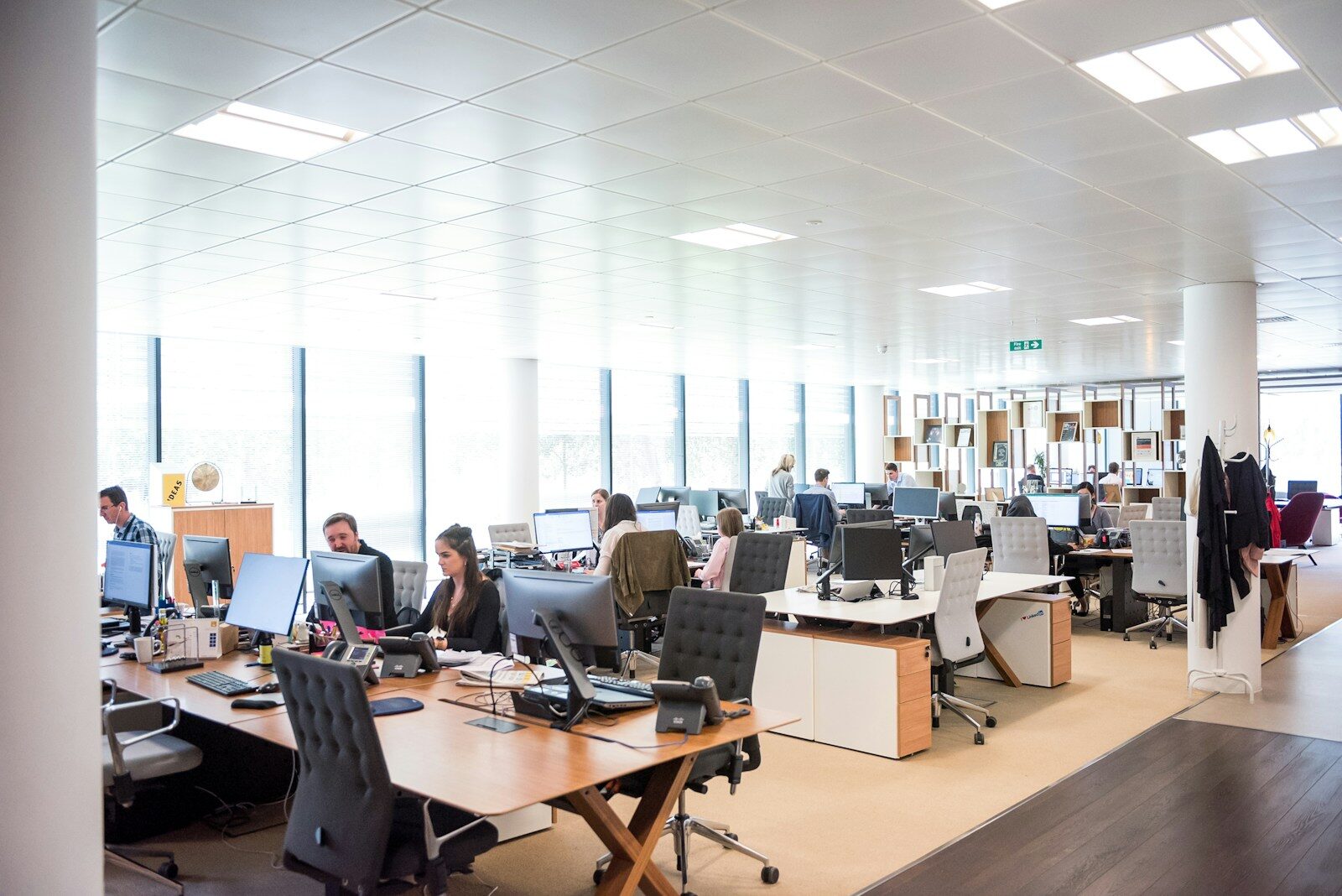 An open-plan office floor with people working at their desks