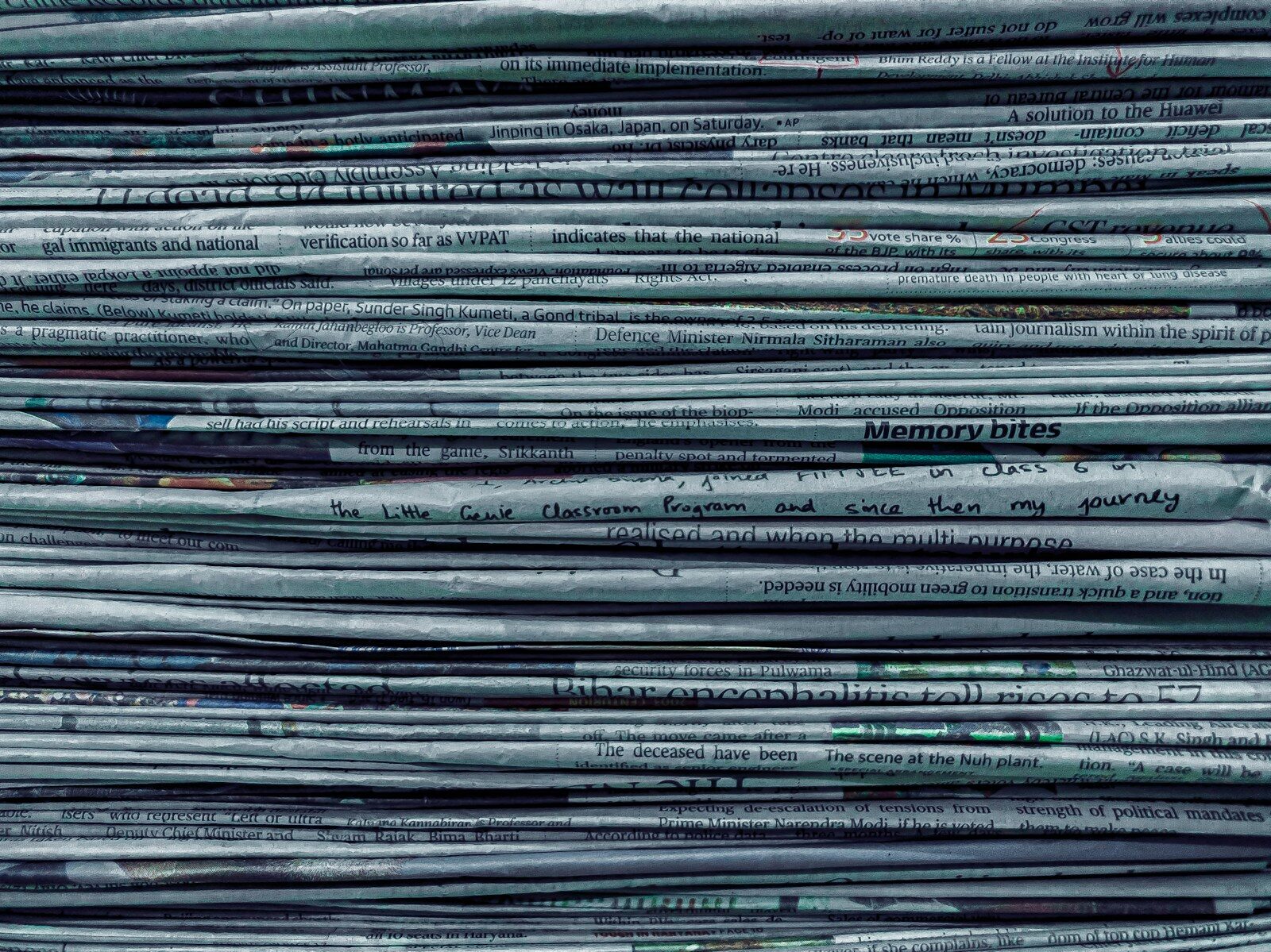A stack of folded newspapers
