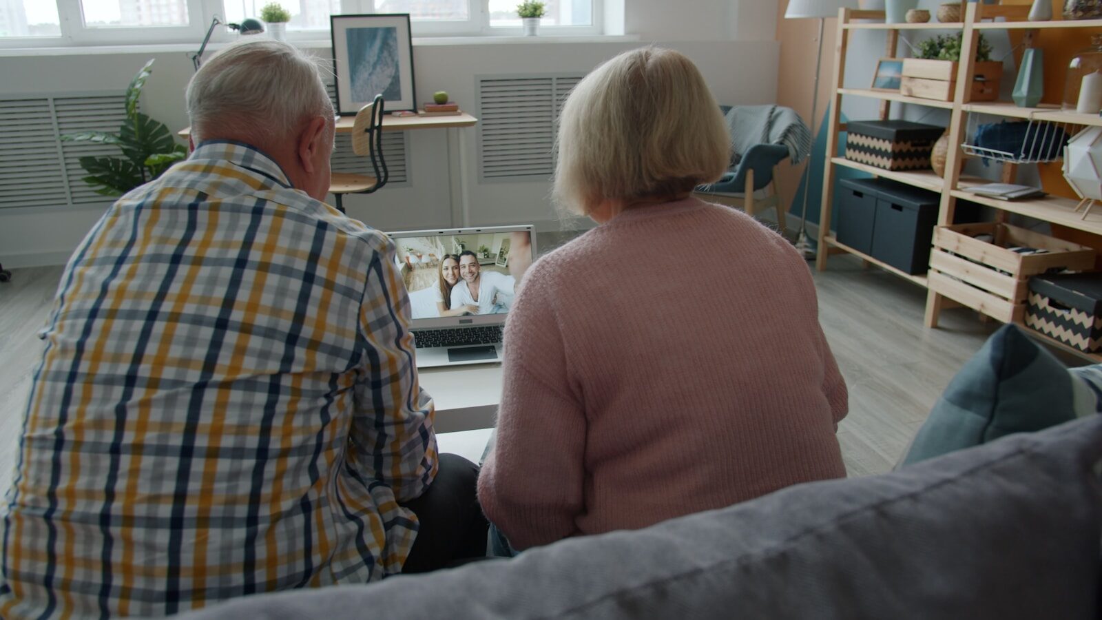 An older couple on a video call with a younger couple