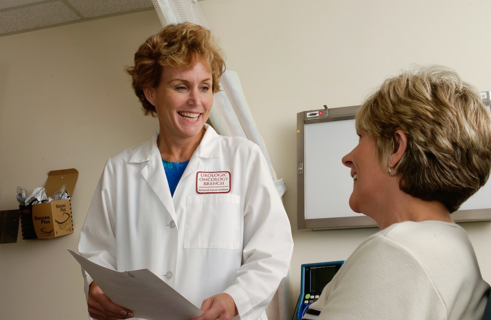 A clinician talking with a patient in a consulting room.