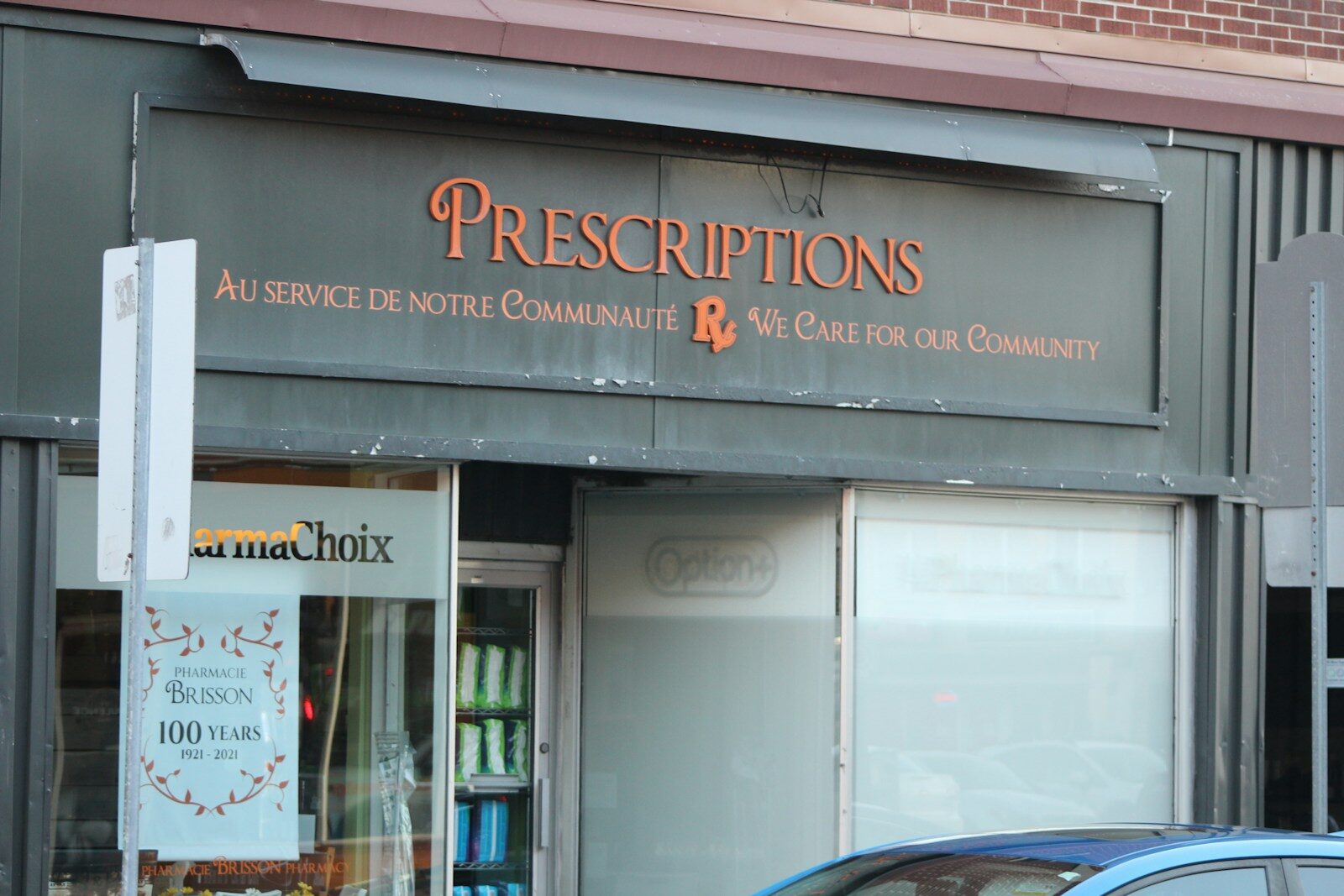 A pharmacy storefront with a prescriptions sign in the window