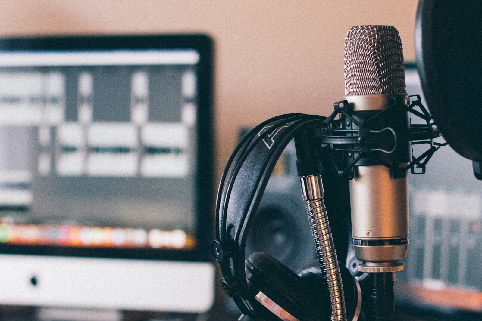 A home podcasting setup with a Røde microphone and AKG headphones