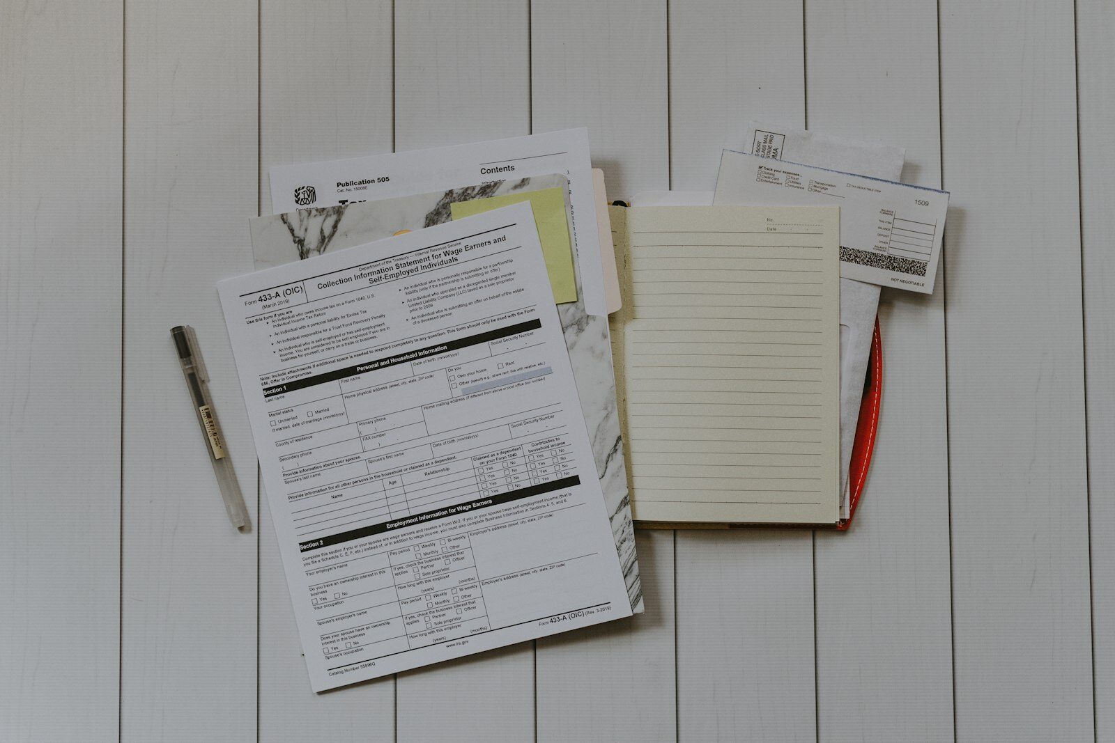 A stack of paperwork photographed flat on a desk.