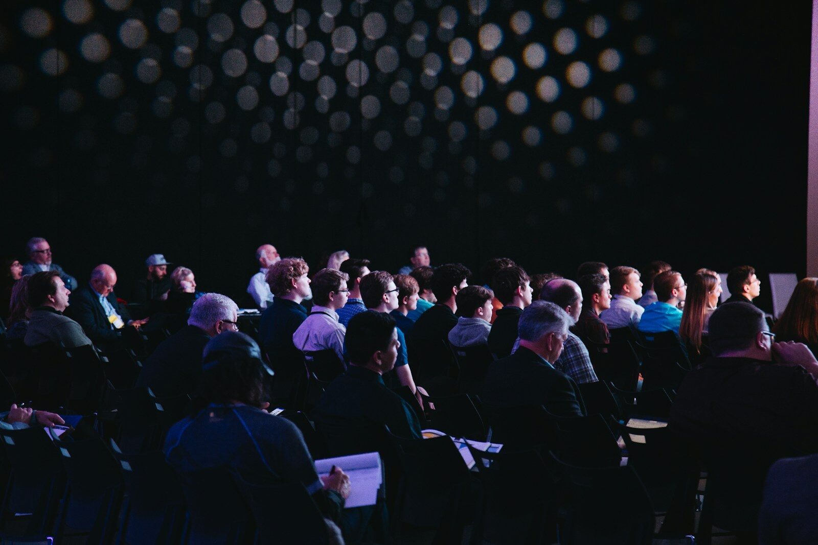 A crowd seated on chairs for a conference session