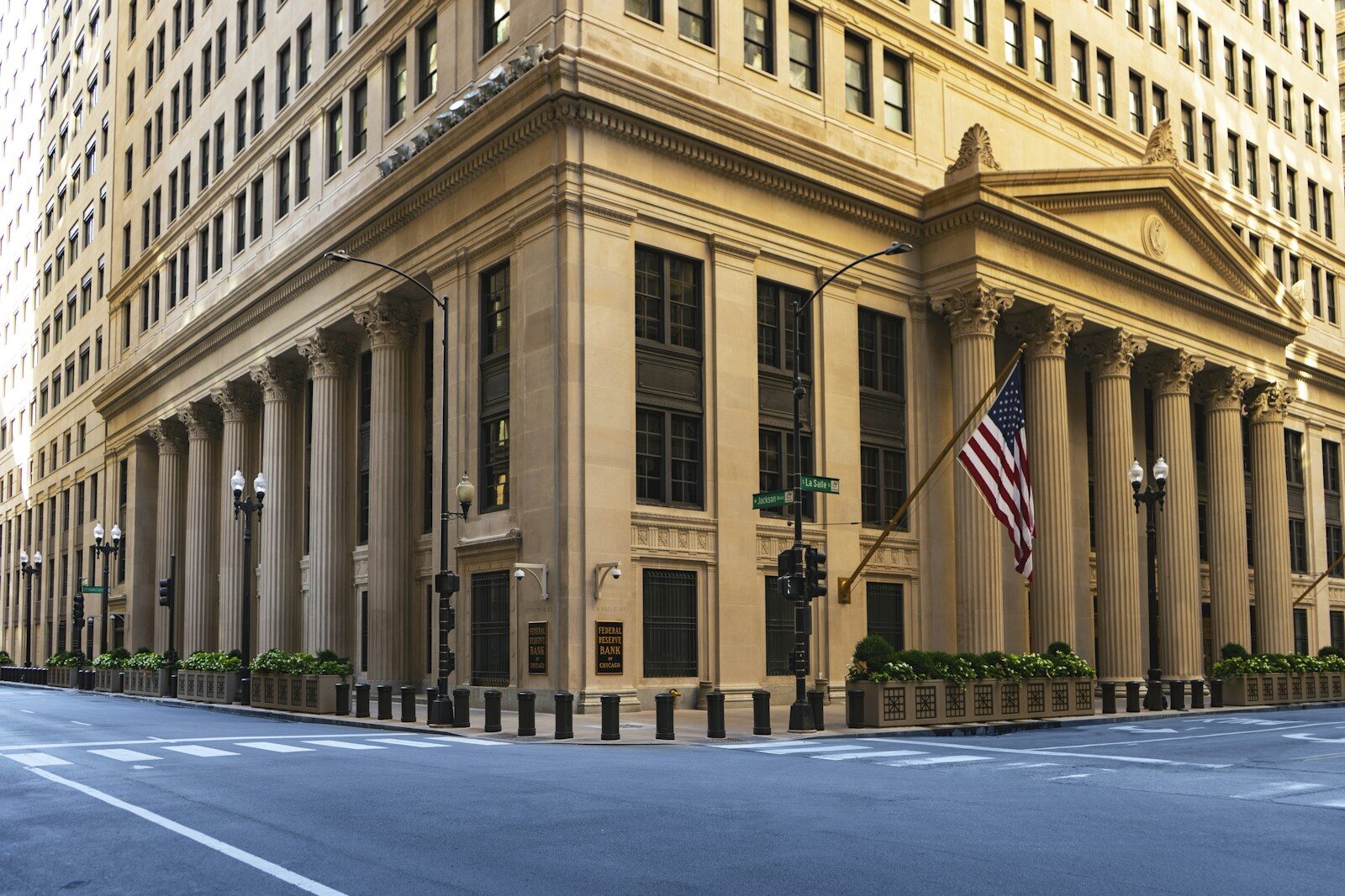 A large columned building with a flag at the corner