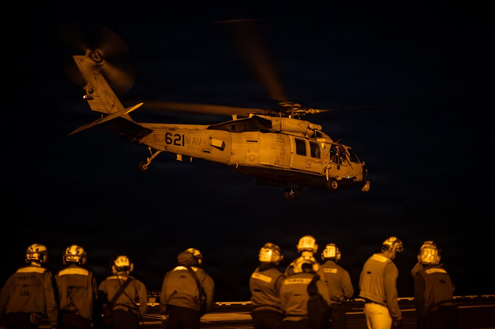 Flight operations on the deck of a US Navy aircraft carrier.