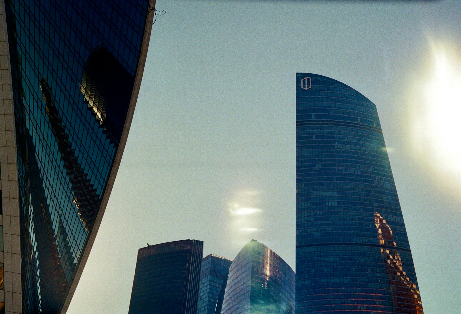 A striking view of the Moscow City business district, featuring modern glass skyscrapers that define the capital's skyline. The architecture reflects power, innovation, and urban dynamism, captured in both close‑up details and full‑building compositions.