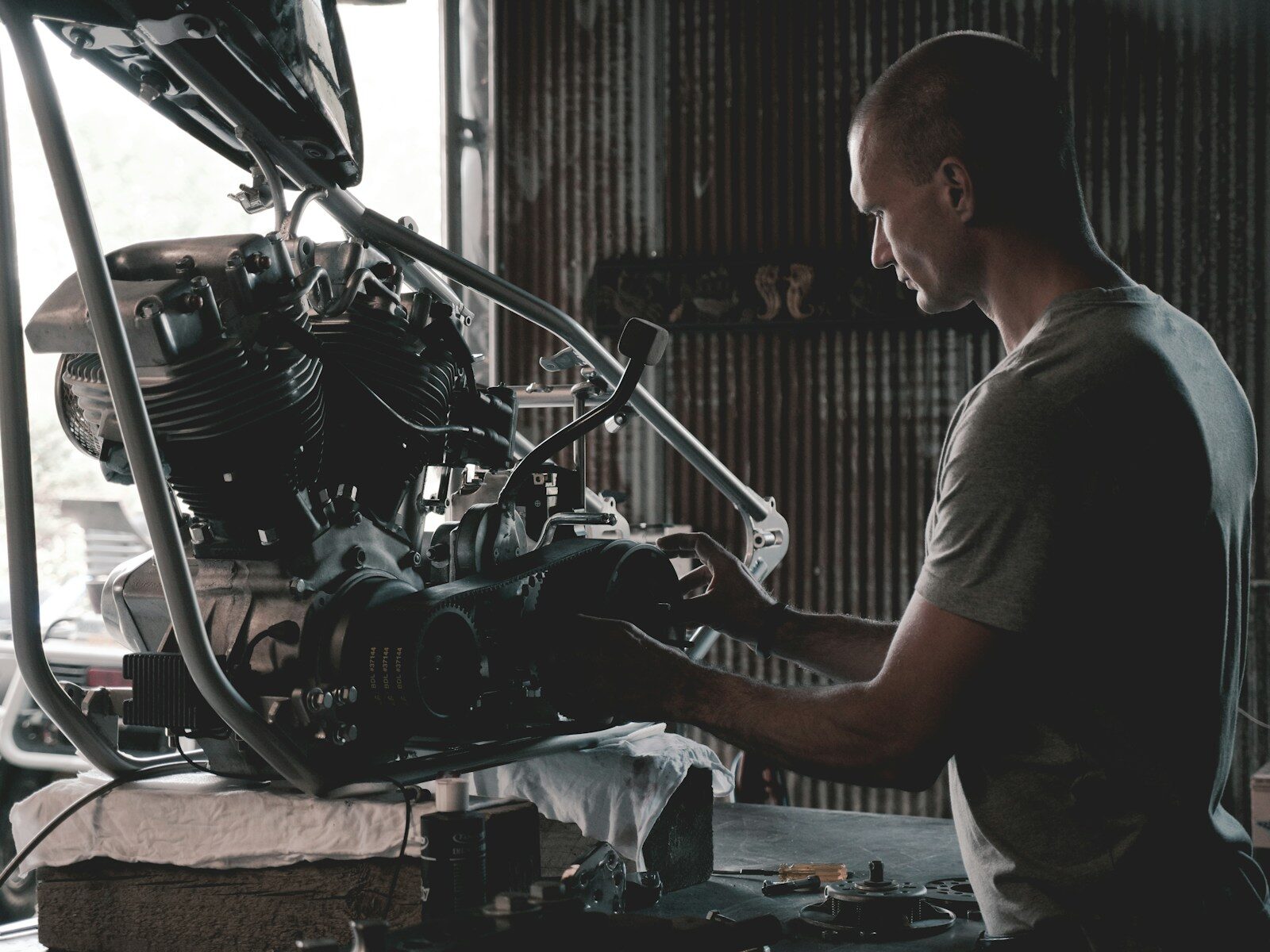 A technician holding an engine component during a service call