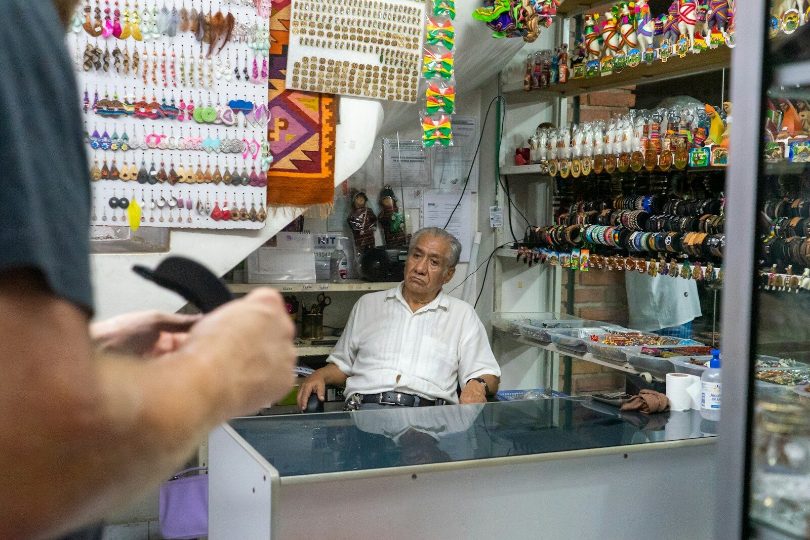 A tired shop owner standing at his counter in Santa Cruz, Bolivia