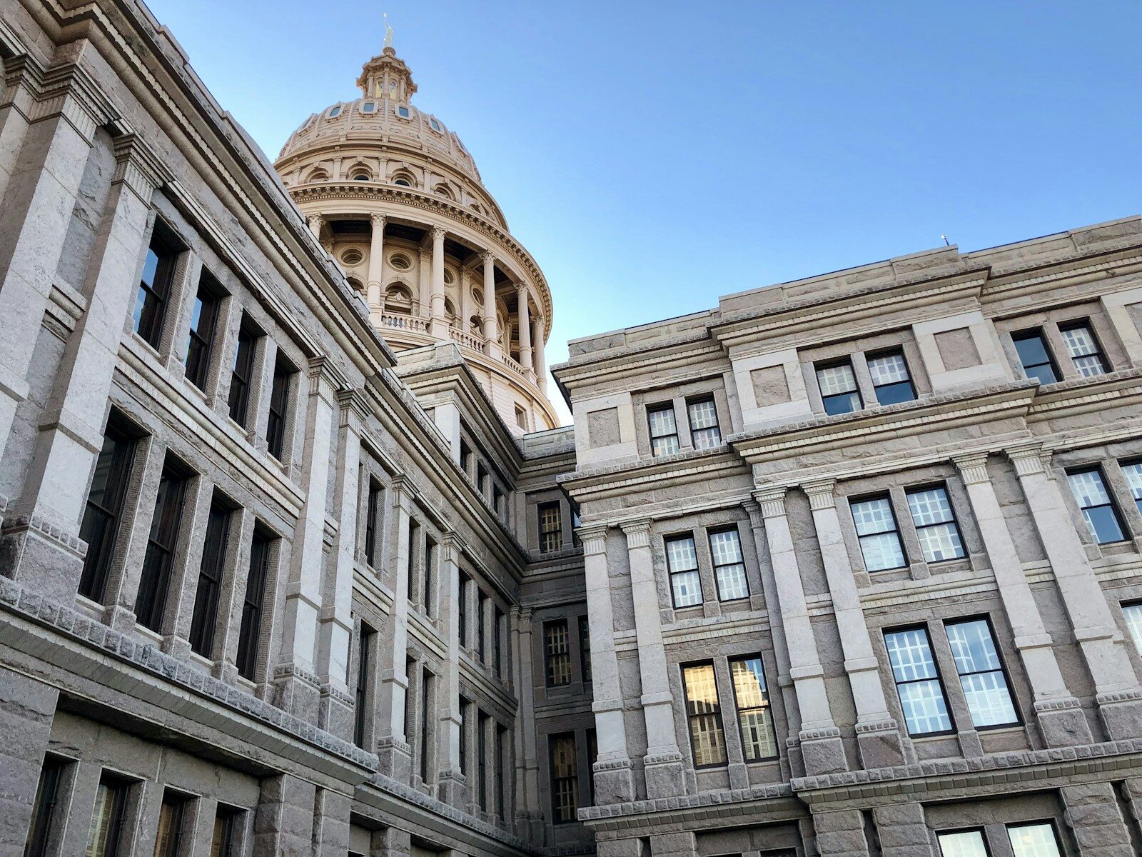 A state legislative building in beige stone