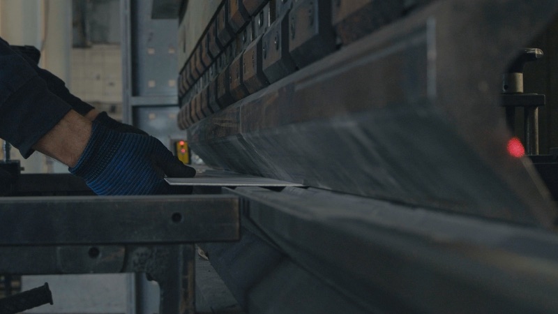 A press brake on a factory floor.