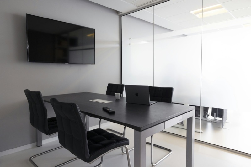 An empty meeting room with chairs around a table.