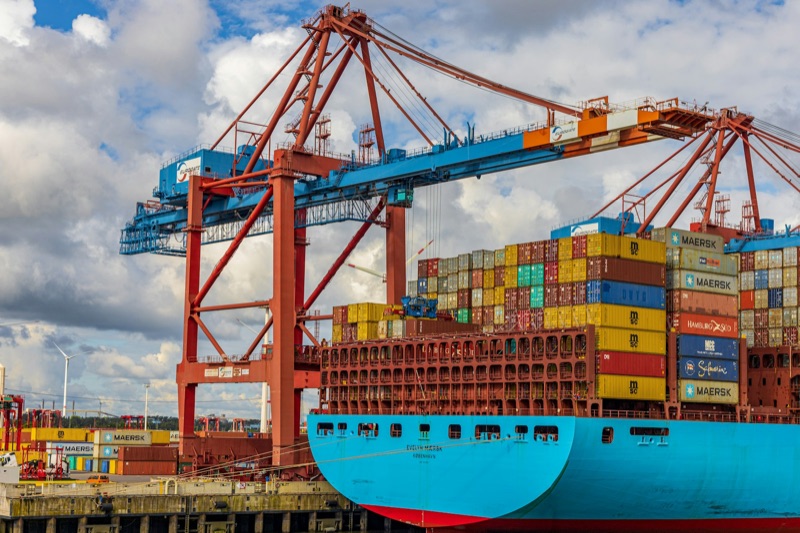 Stacked shipping containers at a port terminal.