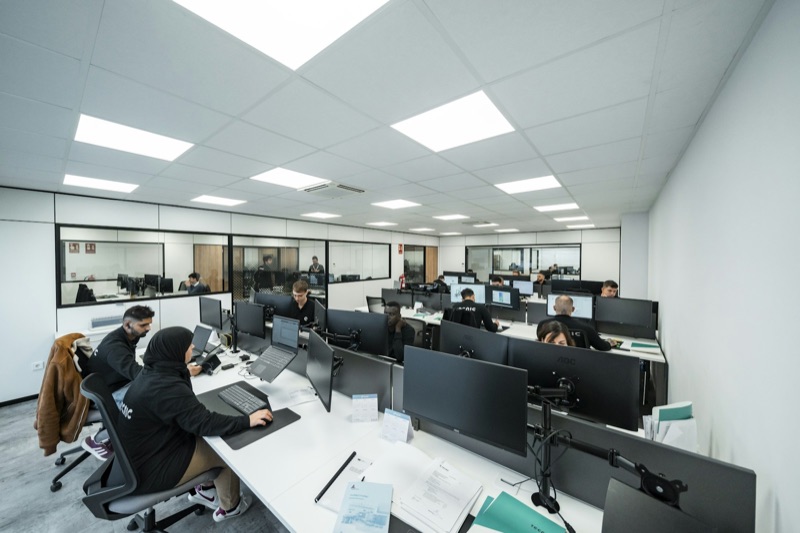 An open-plan office of people working at computers.
