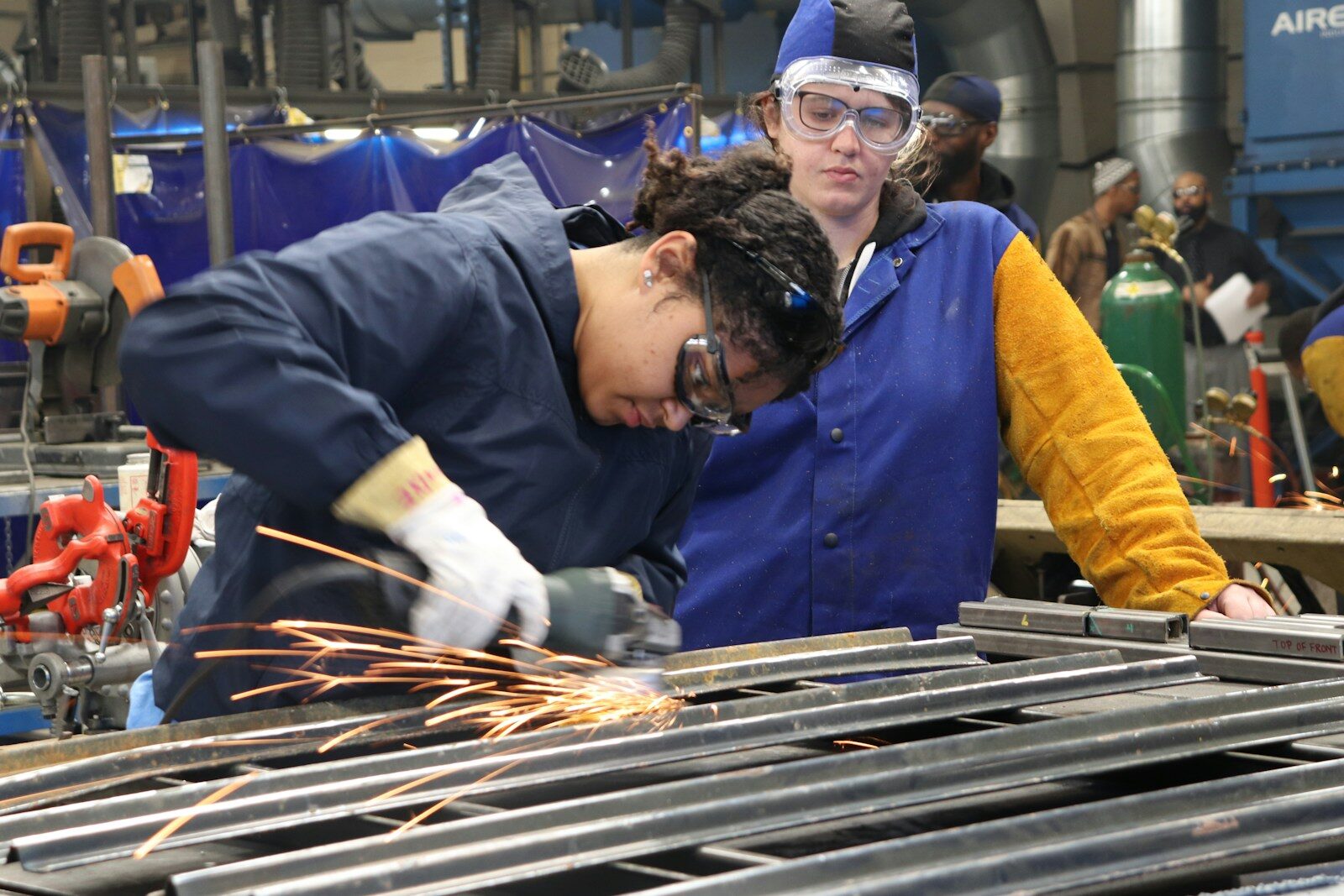 An apprentice in a work vest on site during a training placement