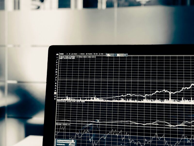 A dark screen displaying a white line graph of financial market data